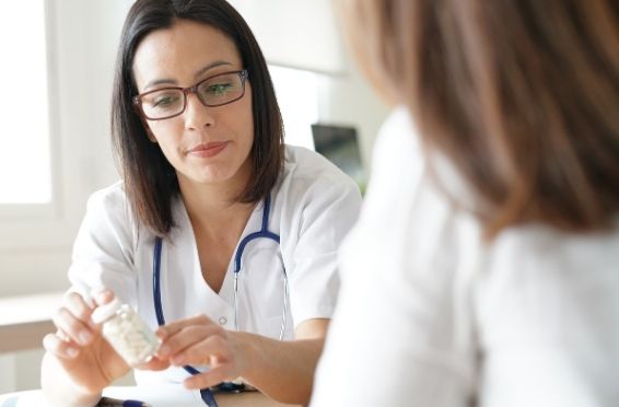 woman taking medication to assist with drug detox - medical detox concept image