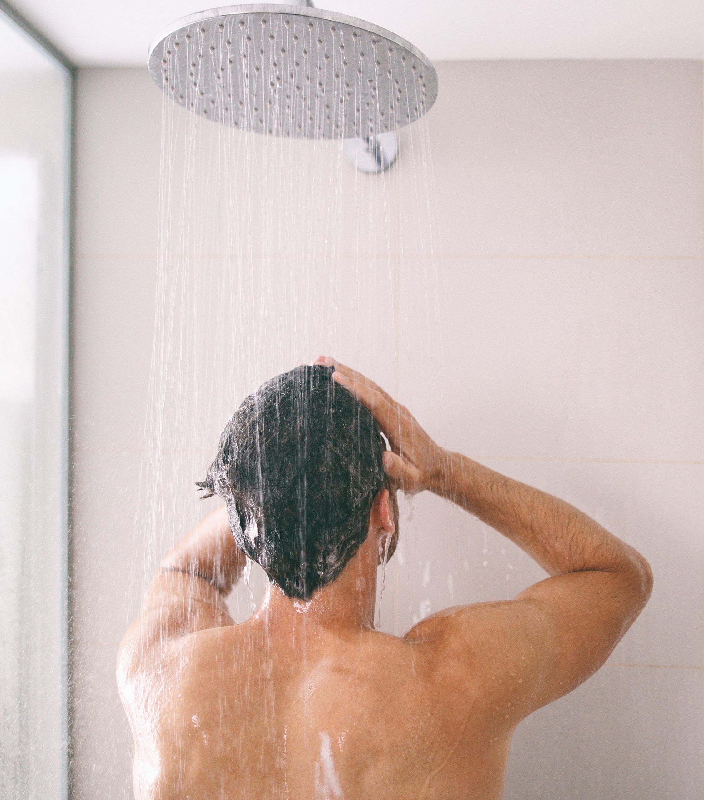 man in shower cleaning hair with drug detox shampoo