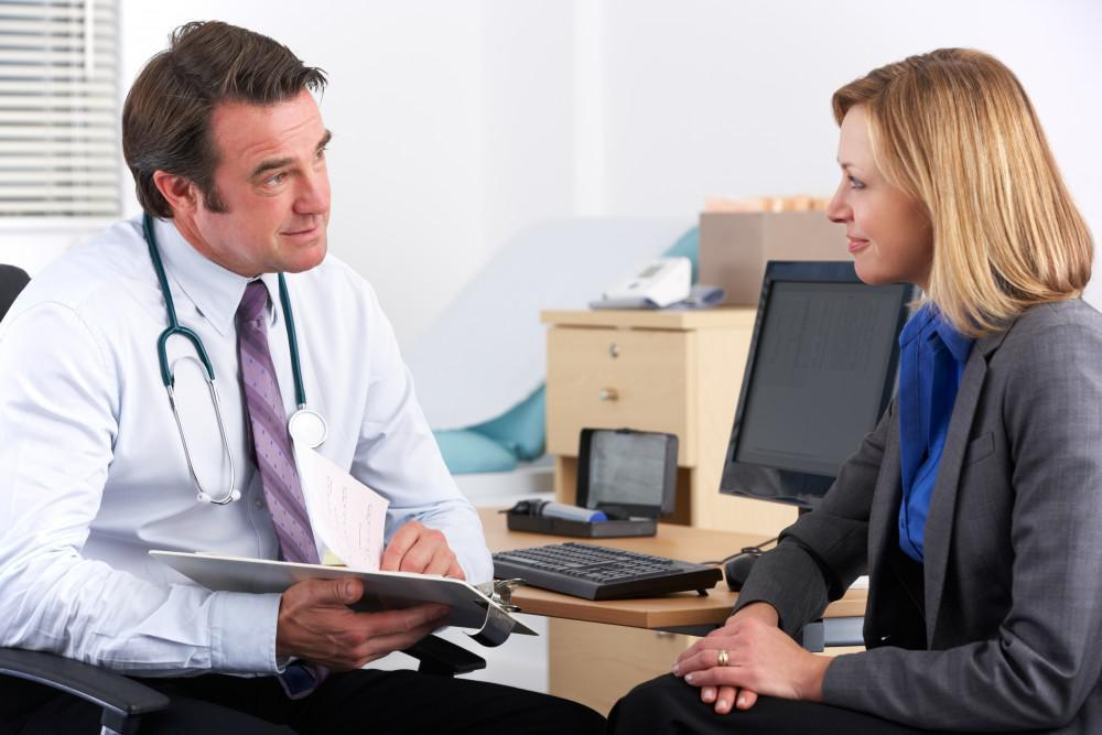 Treatment provider discussing concierge detox services provided with business executive female patient
