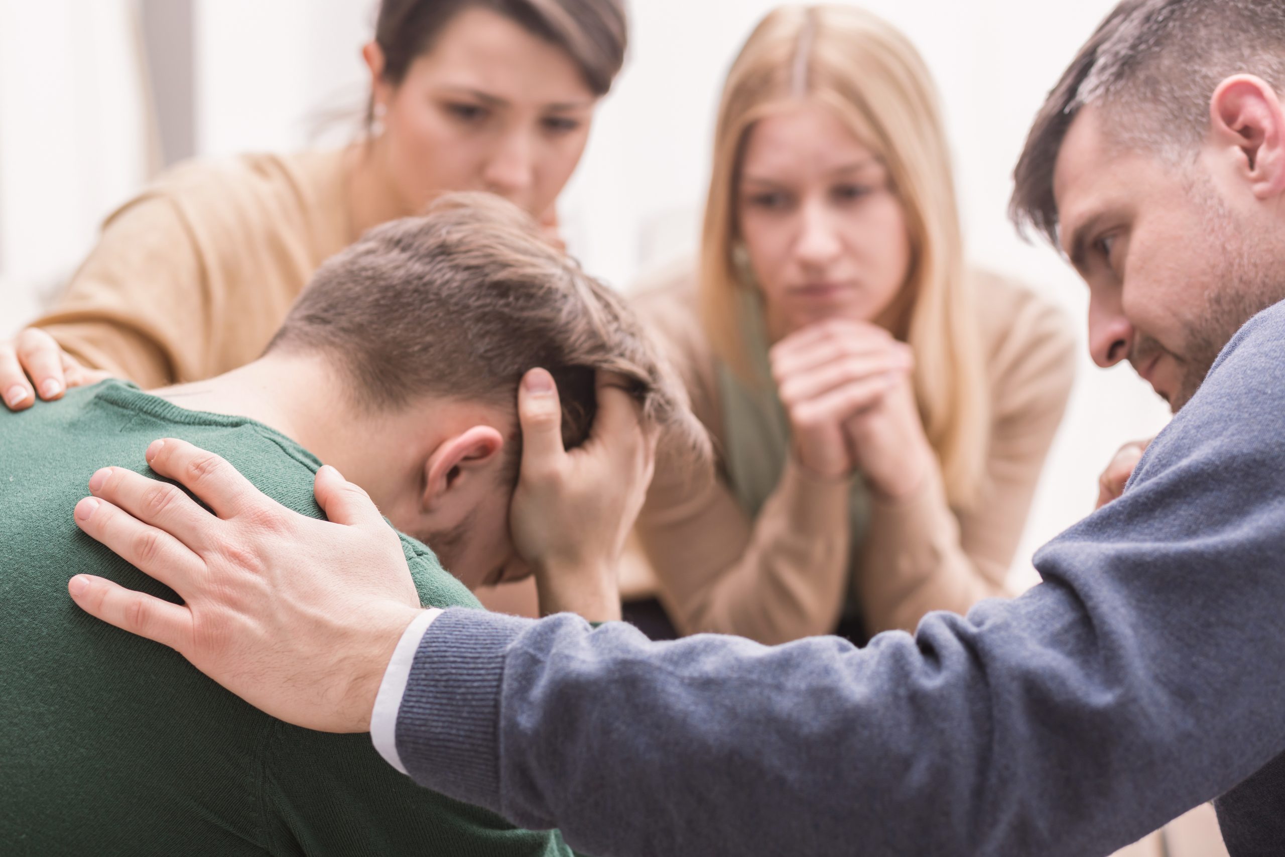 An interventionist and the family members performing and intervention on a loved one in the grips of addiction