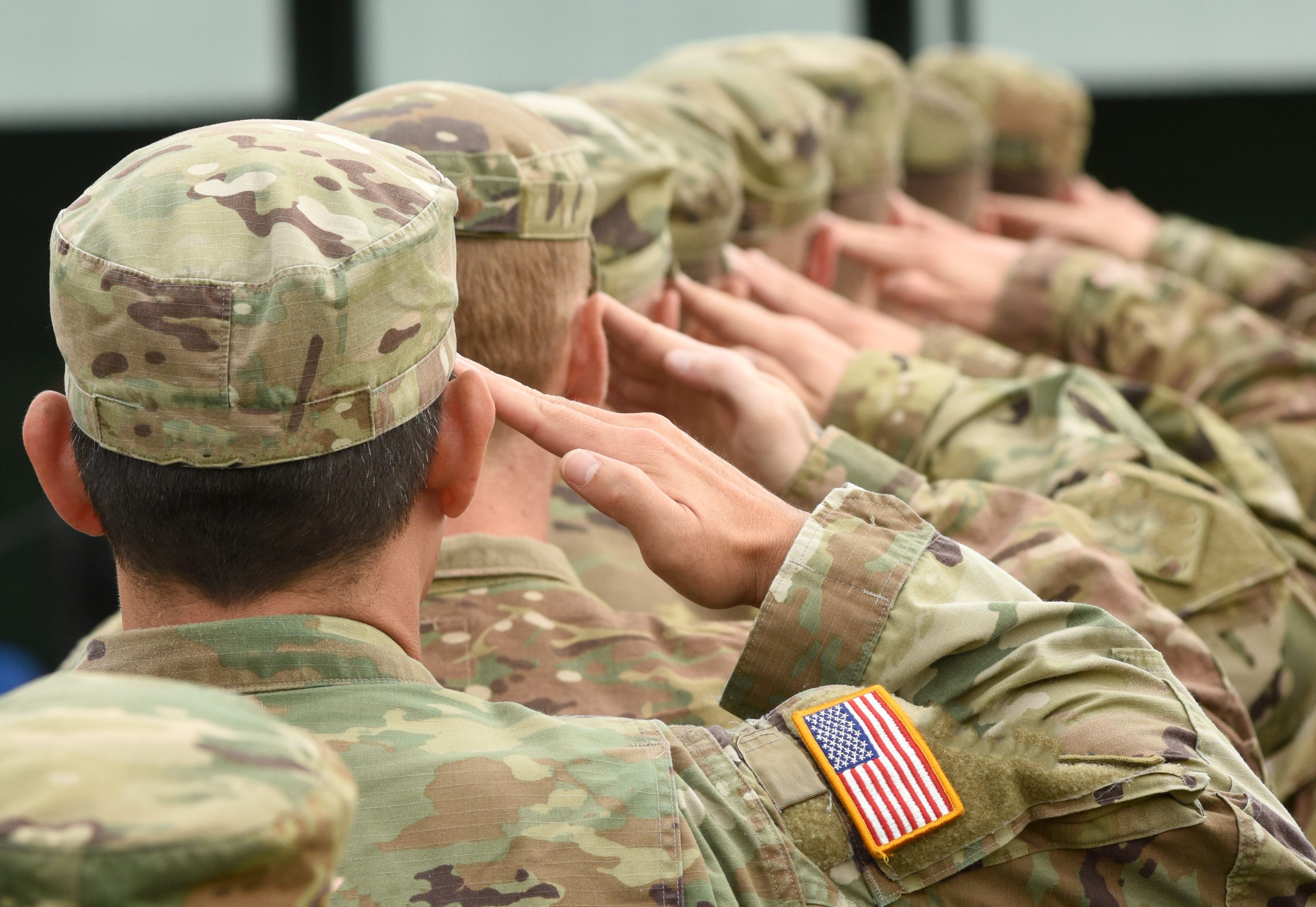 American Military service men in formation and saluting - Addiction among Military Veterans concept image