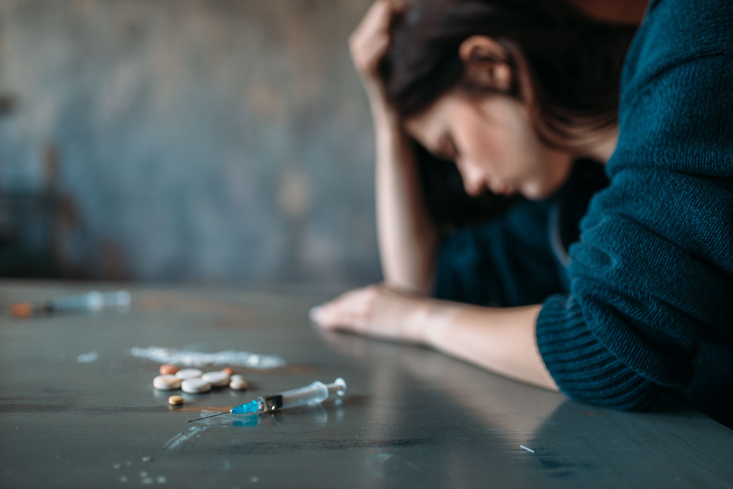 woman suffering from addiction - drug abuse vs drug addiction concept