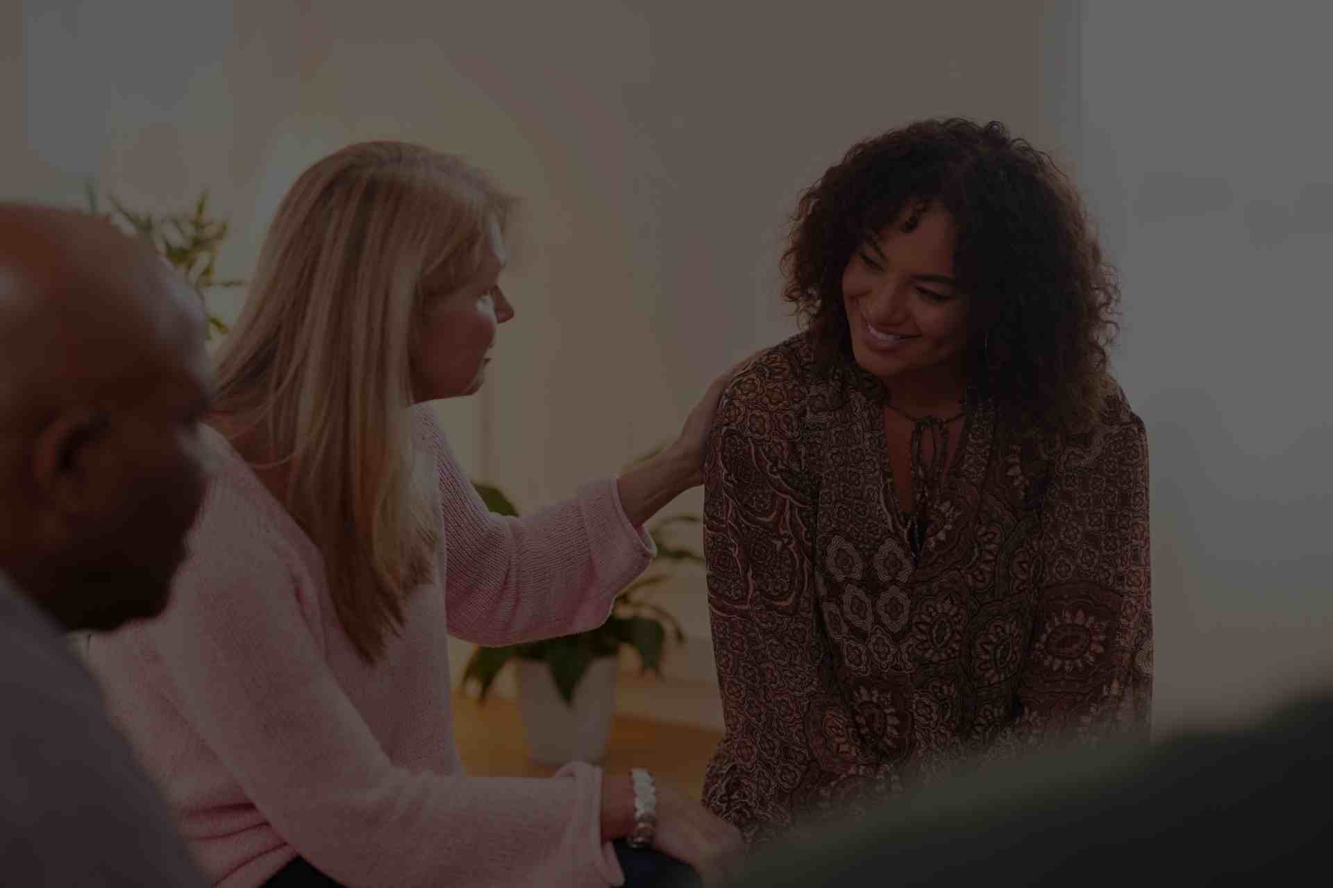 cbt-peer-support-encouragement-recovery Group therapy session with people sharing support during Cognitive Behavioral Therapy for addiction recovery.