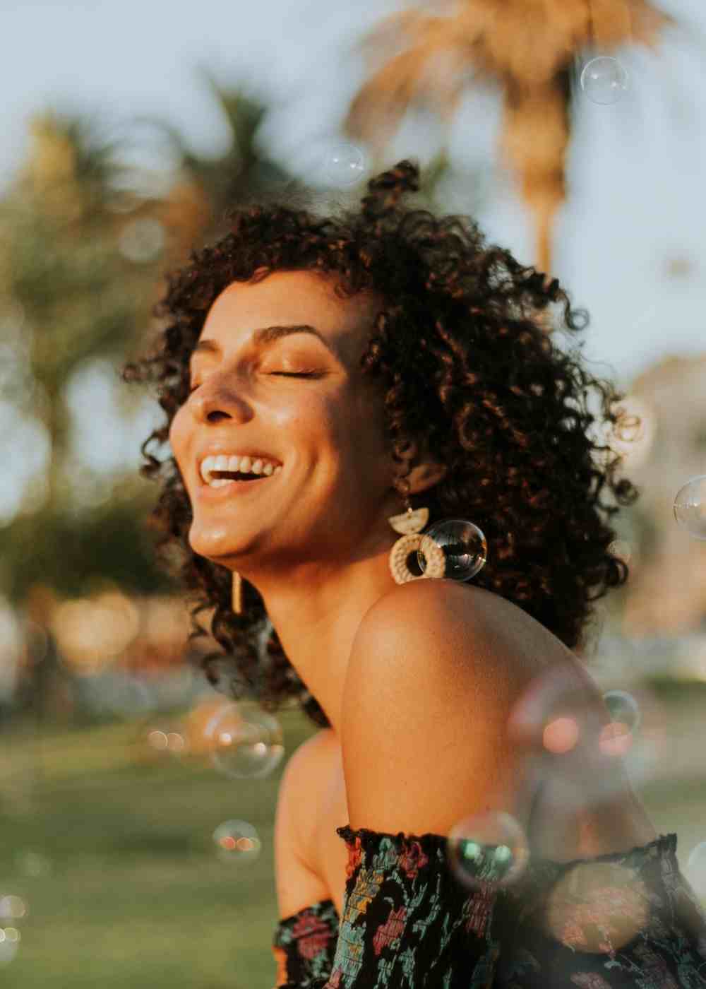 positive-emotions-dbt-recovery-wellbeing Woman smiling outside while building emotional balance through Dialectical Behavioral Therapy in PA.