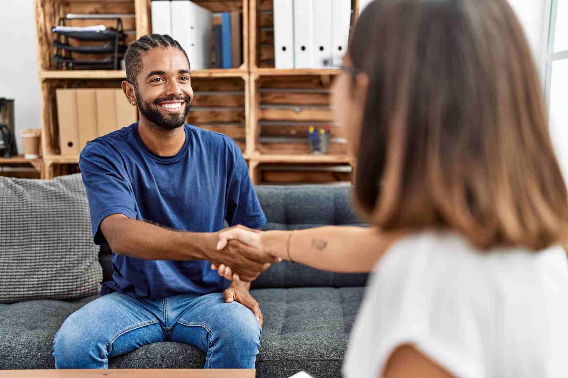 addiction-recovery-intake-consultation Man shaking hands with counselor during addiction recovery consultation
