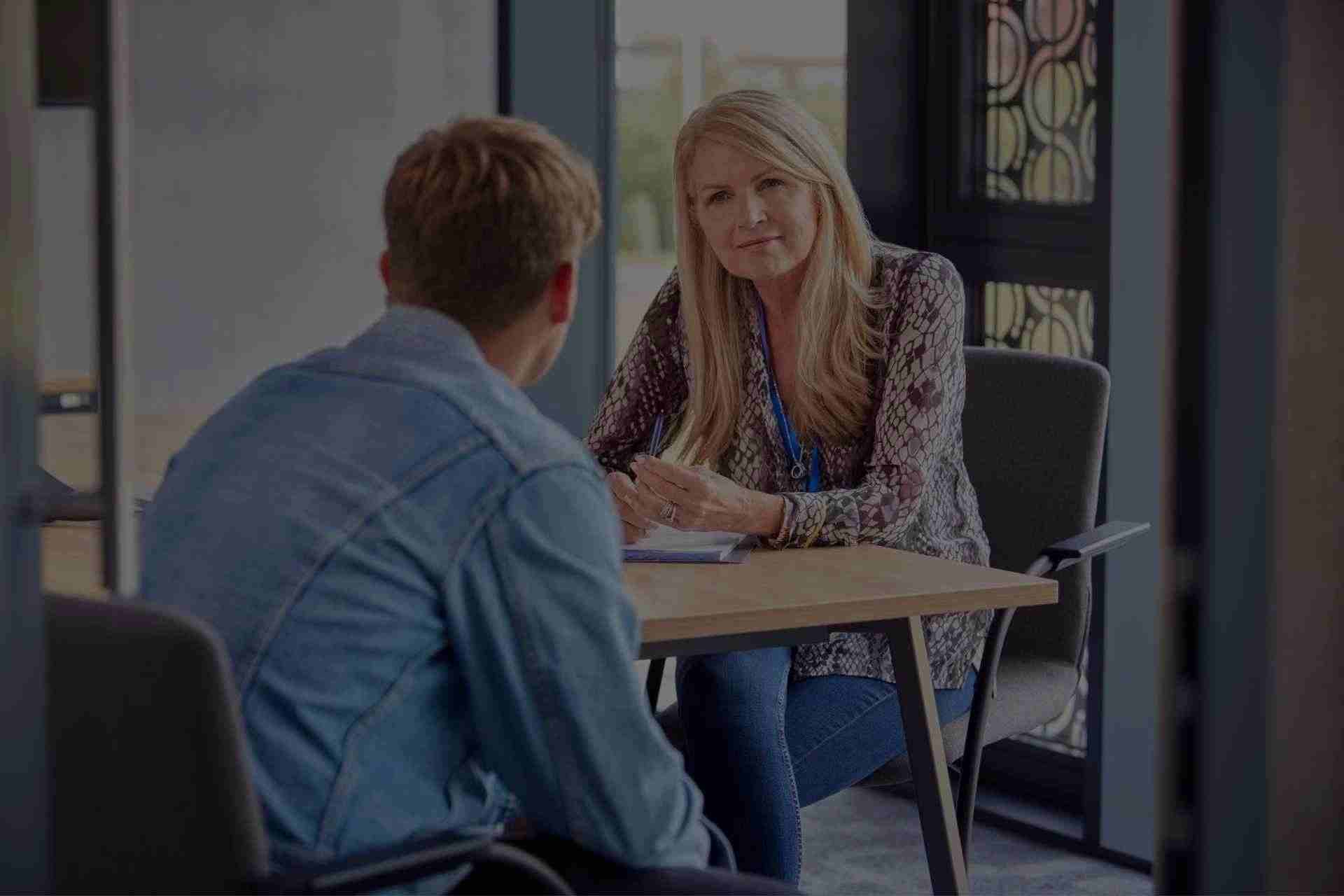 individual-therapy-for-addiction-recovery. Group therapy session with people sharing support during Cognitive Behavioral Therapy for addiction recovery.