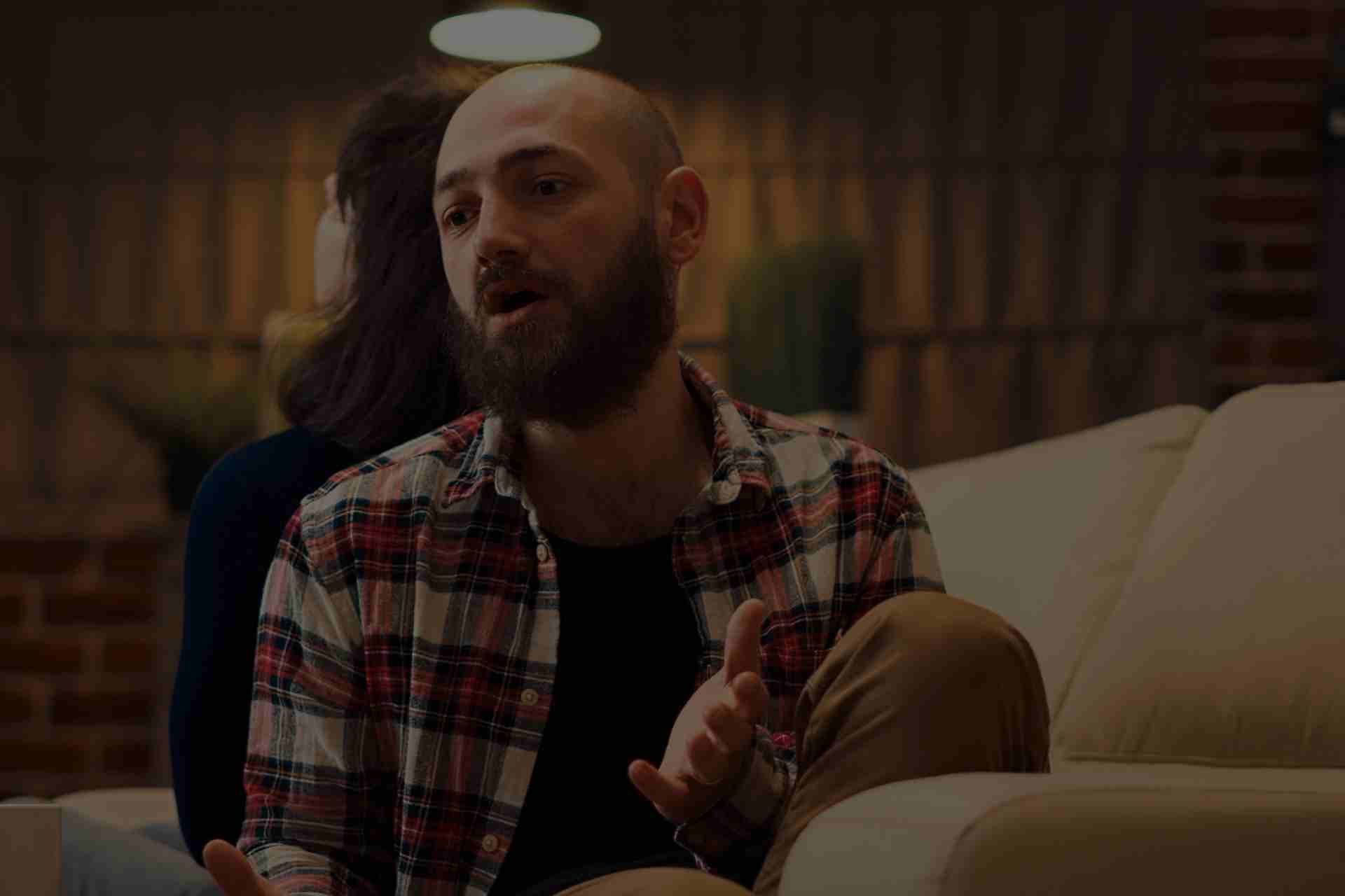 peer-support-group-therapy-addiction-recovery Group therapy session with people sharing support during Cognitive Behavioral Therapy for addiction recovery.