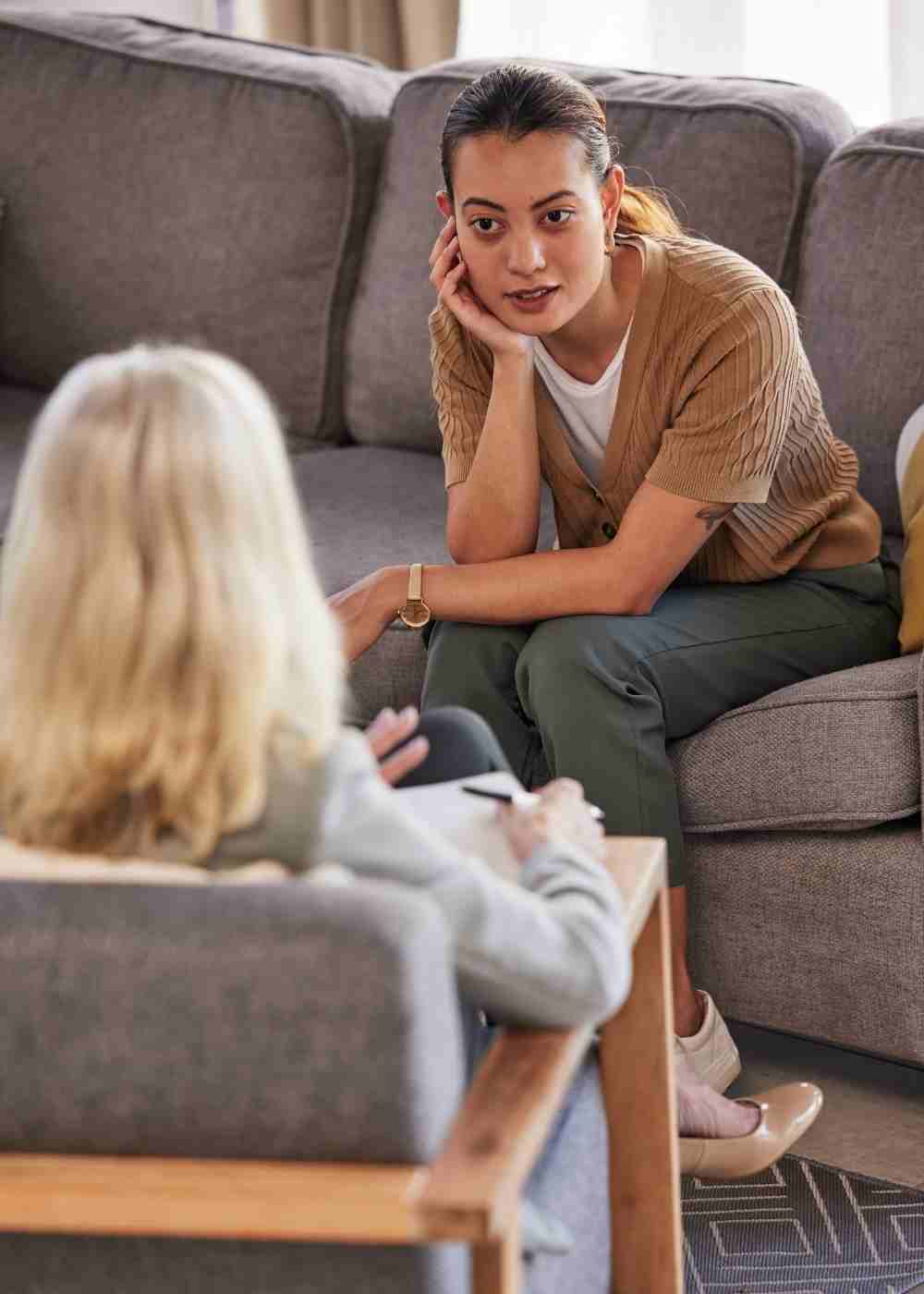 personalized-therapy-mental-health Woman smiling with a mug while finding calm through Cognitive Behavioral Therapy for addiction recovery.