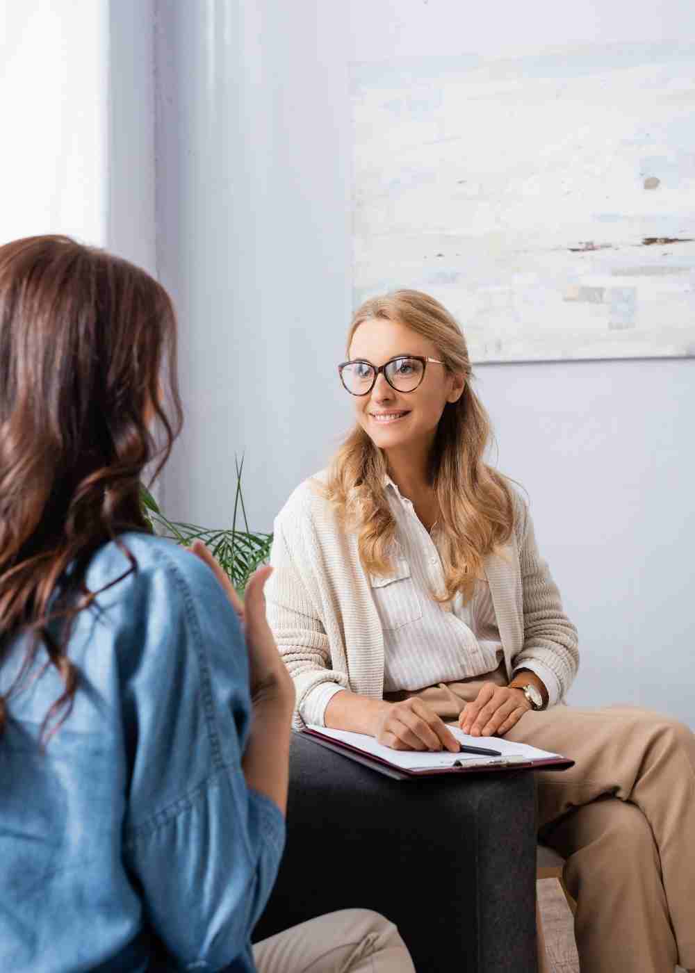 professional-counseling-services Woman smiling with a mug while finding calm through Cognitive Behavioral Therapy for addiction recovery.