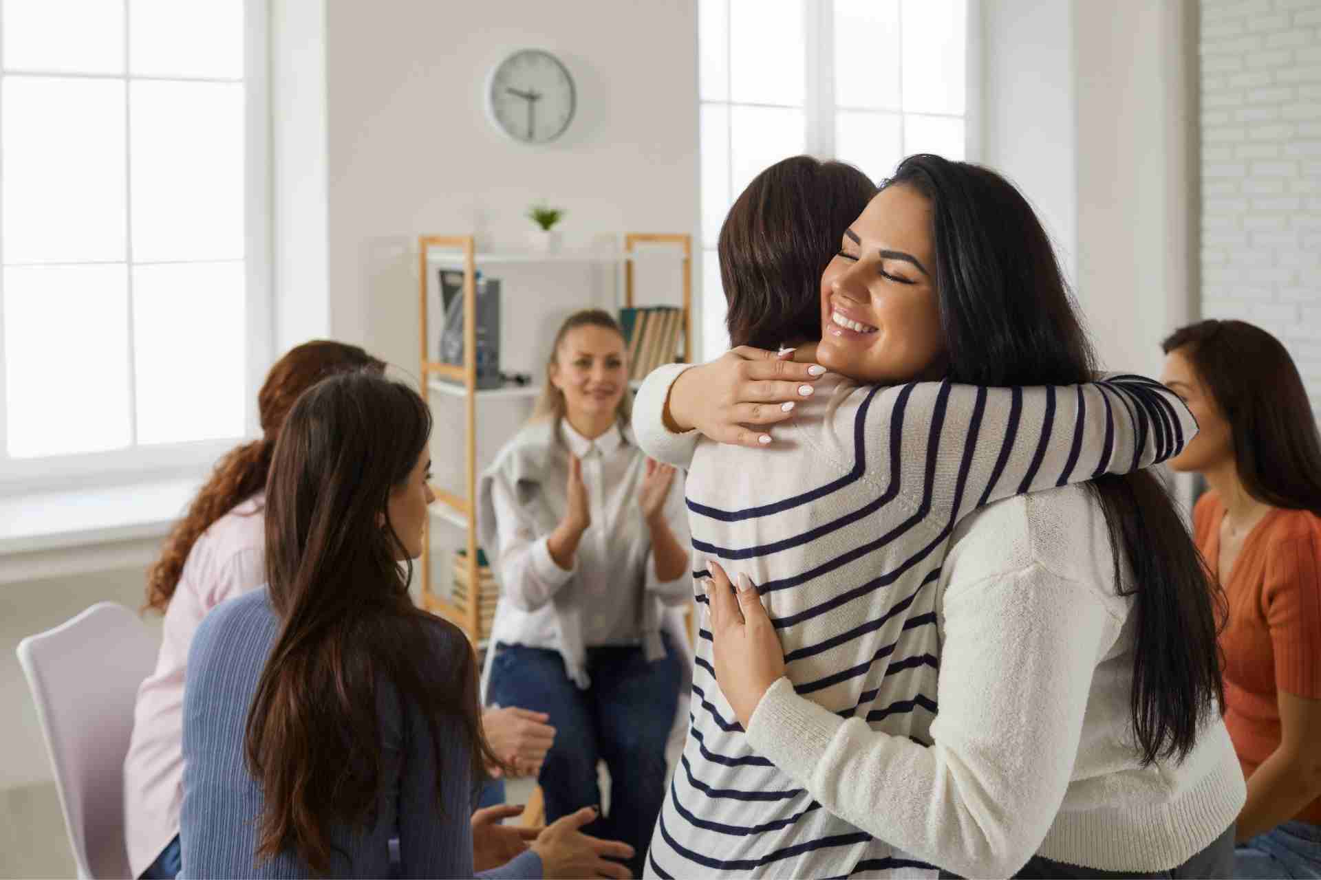 trauma-informed-group-therapy-support-pennsylvania Person receiving a supportive hug during trauma-informed group therapy in Pennsylvania