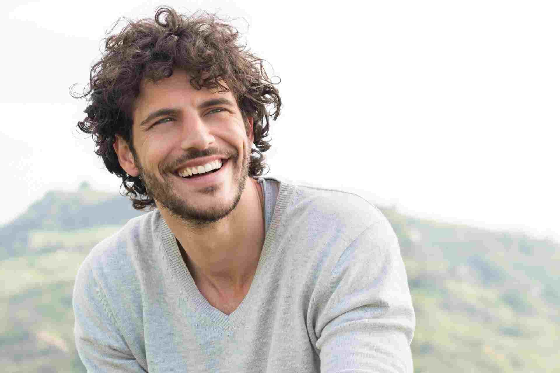 drug-detox-recovery-man Smiling man outdoors representing improved well-being and recovery after completing drug detox treatment.